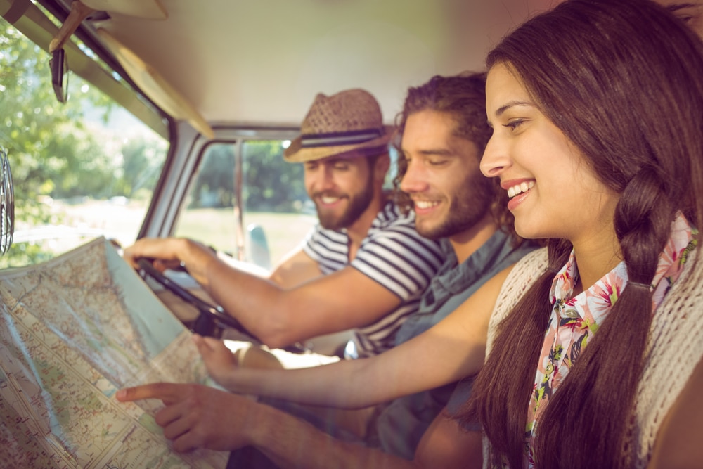 A retro photo of three young people on a road trip