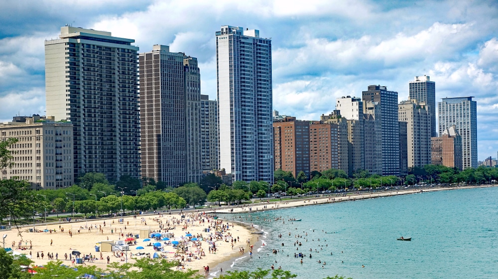 View of the beach off of Lake Michigan, with the Chicago skyline in the background.