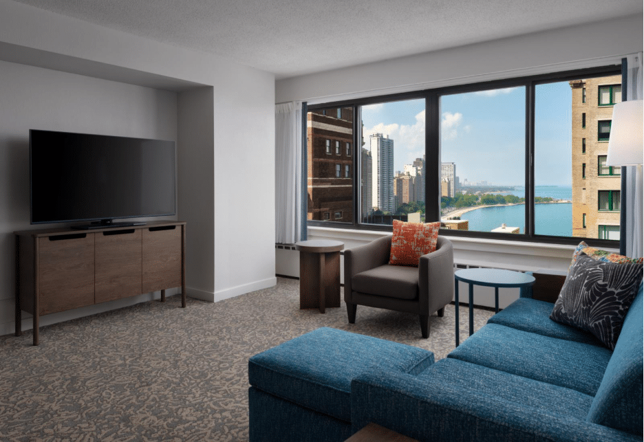 View of a room in the Sonesta ES Suites Chicago Downtown Magnificent Mile with a living room with view of the Chicago Riverwalk.