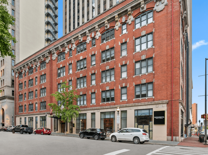 A red brick building featuring numerous windows, showcasing a classic architectural design.