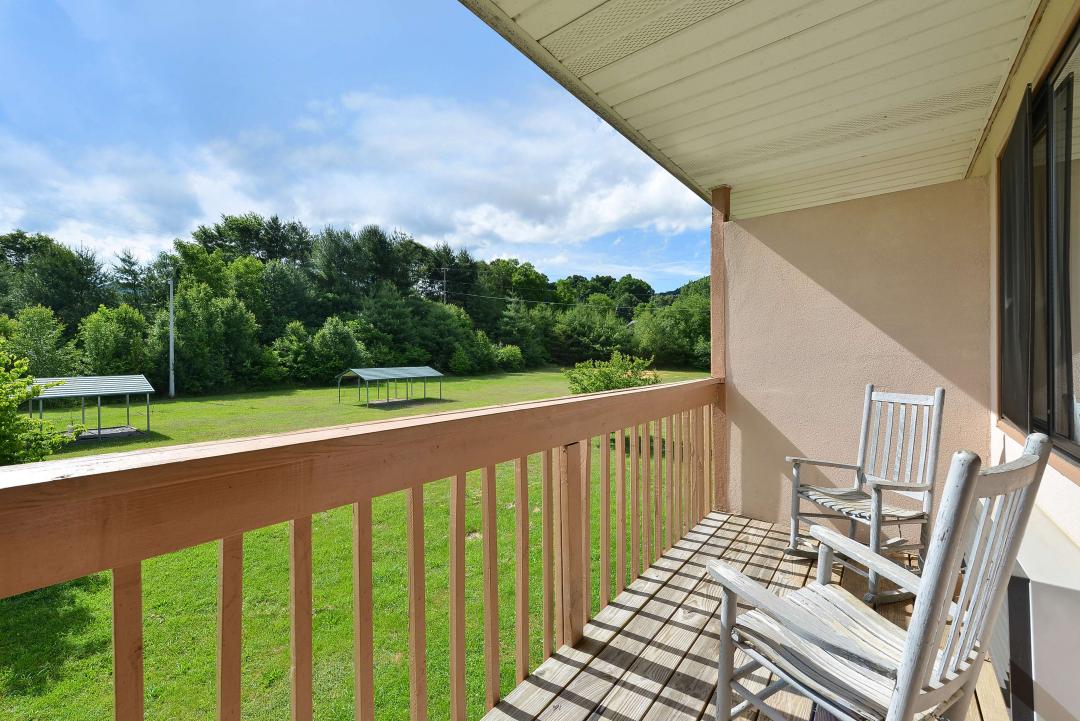 A staircase ascending towards a vibrant waterfall surrounded by autumn foliage.