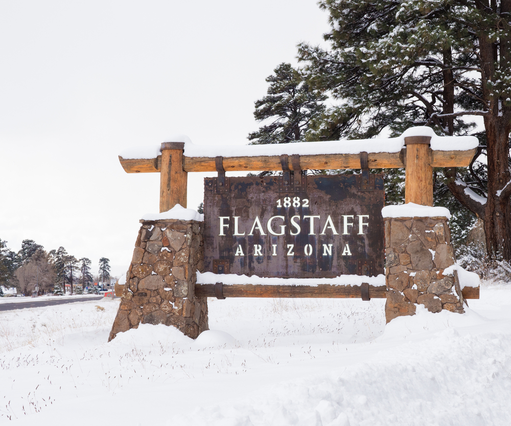 A sign displaying the text "Flagstaff Arizona" against a natural background.