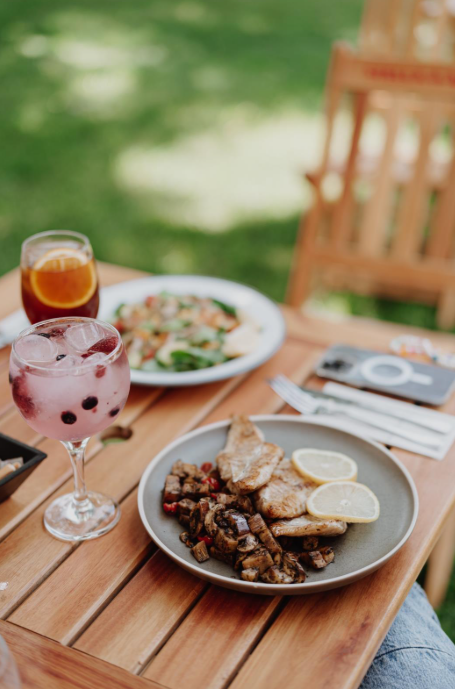 A table set with various dishes and drinks, showcasing a colorful spread of food for a gathering.