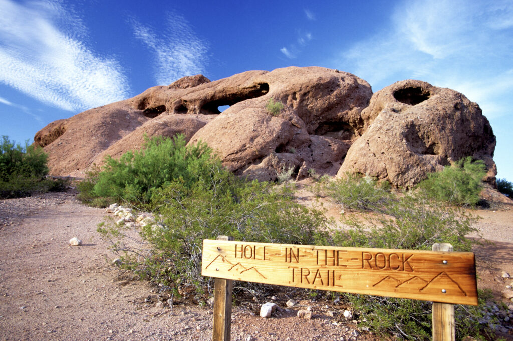 A sign displaying the text "tour the rock" in bold letters against a simple background.