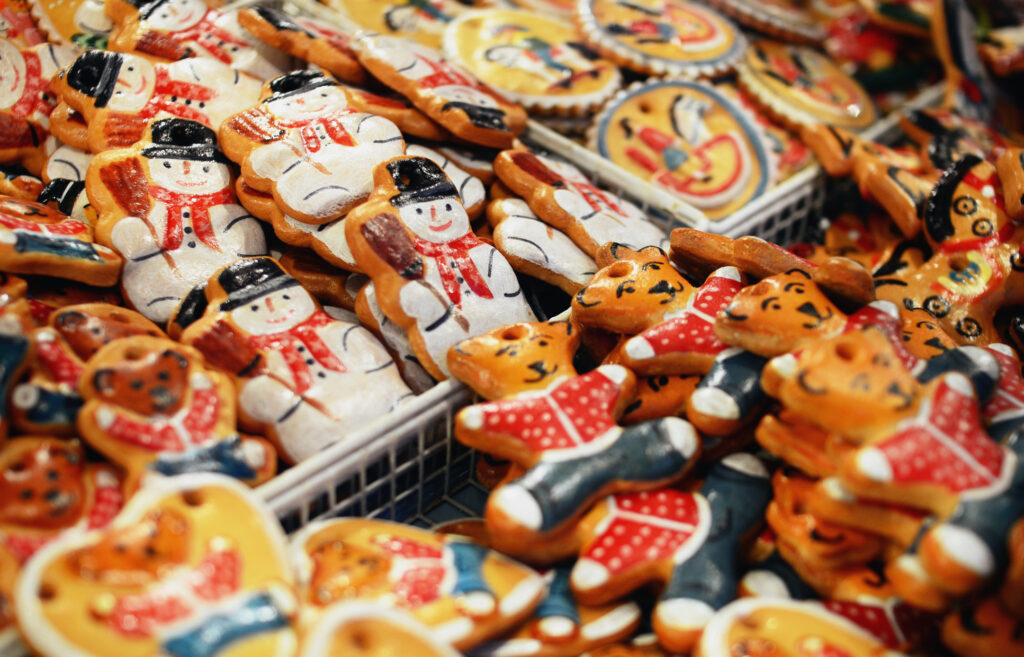 A display of colorful Christmas cookies arranged attractively at a festive market stall.