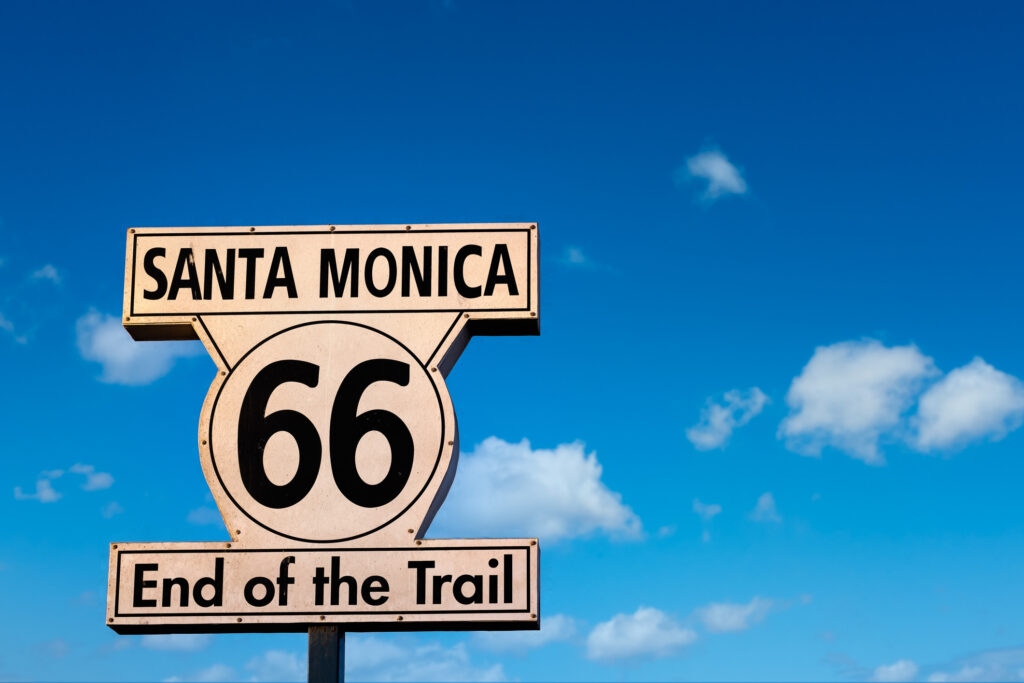 The iconic sign for the end of Route 66, where the highway meets the Pacific Ocean in Santa Monica, Los Angeles, California 