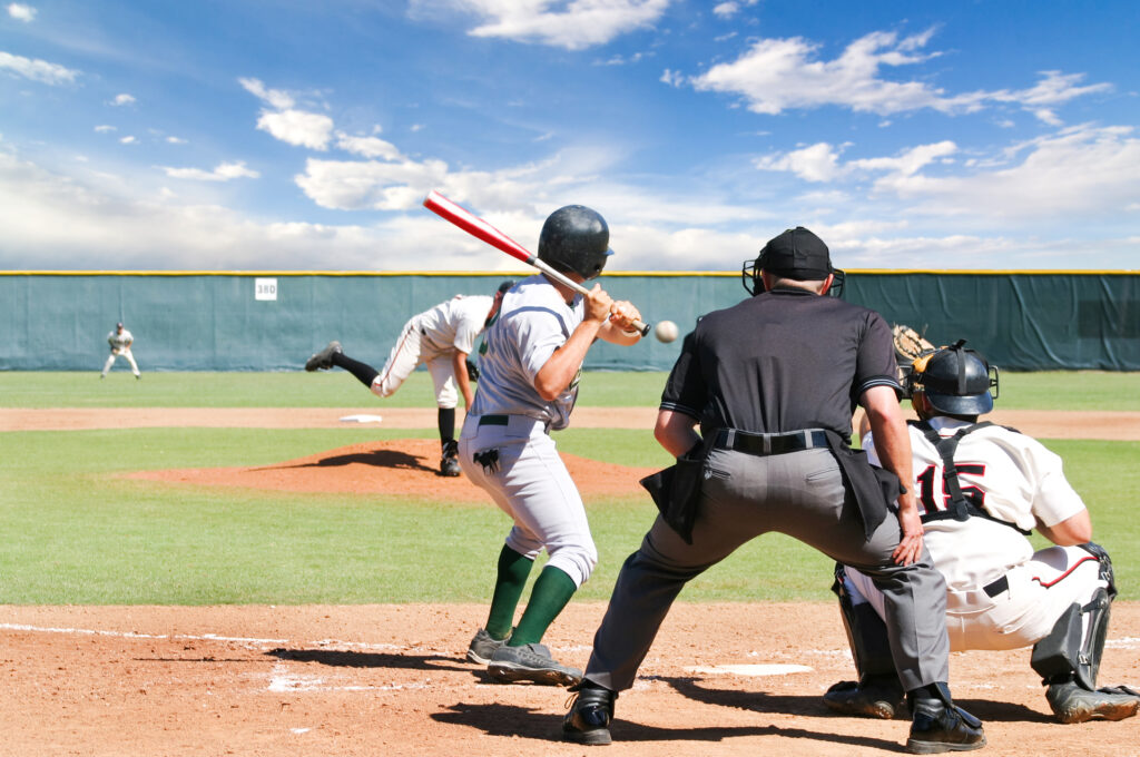 Spring Training Baseball scene. Pitch on its way with umpire, catcher, and batter waiting.