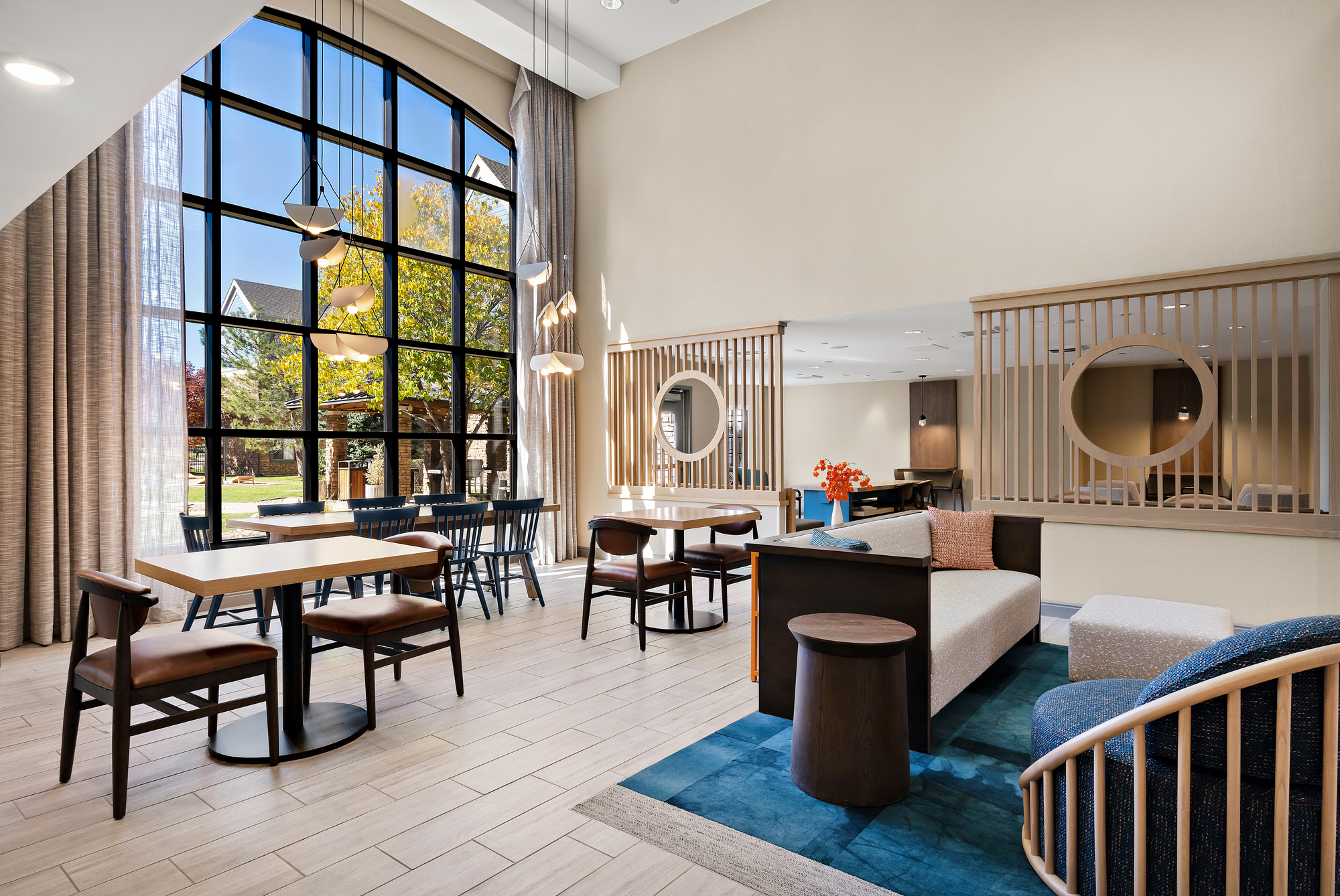 Hotel lobby featuring large windows that allow natural light to illuminate the space.