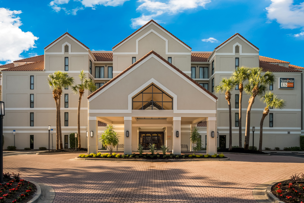 Exterior view of a hotel, showcasing modern architecture and landscaped surroundings.