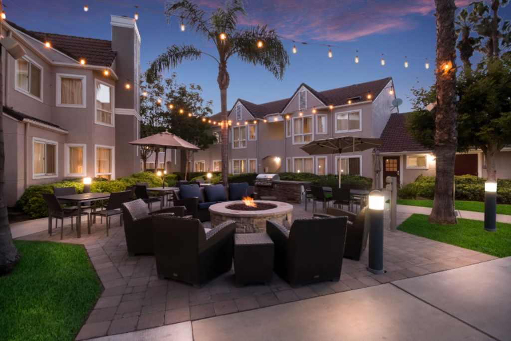 Outdoor patio at the lodge illuminated by string lights, creating a warm and inviting nighttime atmosphere.
