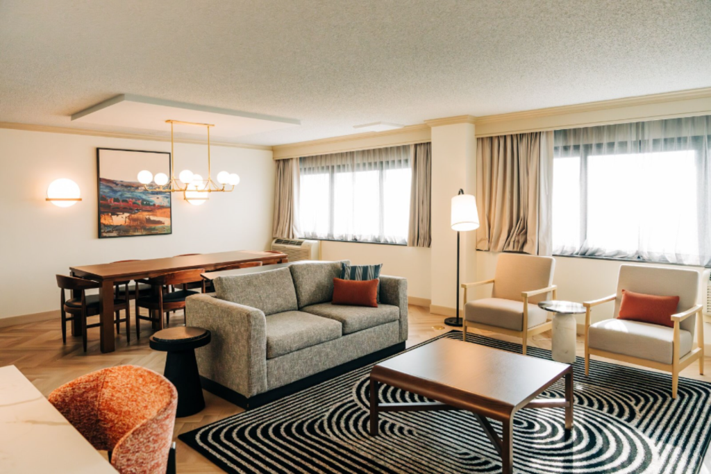 A cozy room featuring a couch, an armchair, and a coffee table arranged for relaxation and socializing.