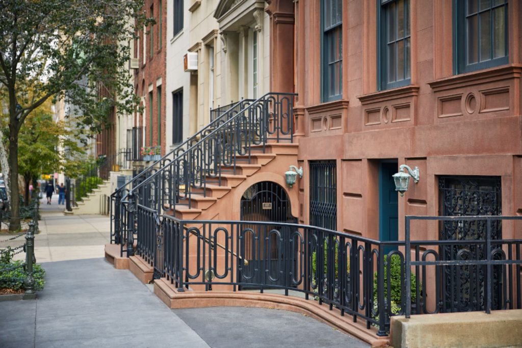 A black wrought iron railing with intricate designs, providing support and aesthetic appeal to a staircase or balcony.