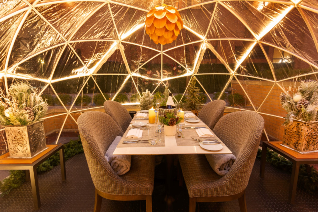 A spacious dining room featuring a large, elegant dome ceiling that enhances the room's grandeur and ambiance.